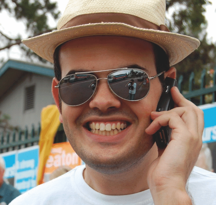 Dave Burnett smiling on the phone at a campus event